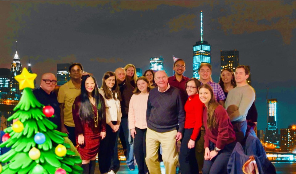 A group photo of those mentioned in the caption, in front of the NYC skyline.