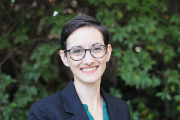 Glasses, dark hair, short, big smile