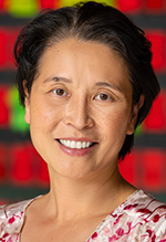 An Asian woman with short dark hair smiles