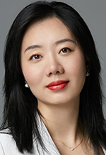 An Asian woman with long dark hair smiles