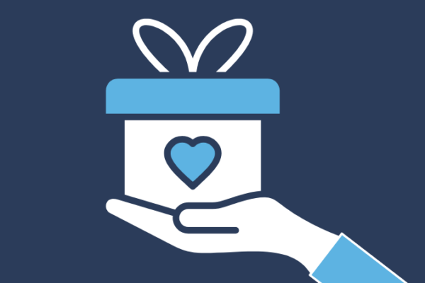 A hand holding a gift. The gift has a heart on it.