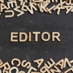 The word EDITOR surrounded by wooden letters