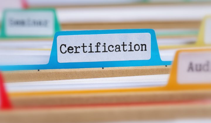 multiple file folders. The centered file has certification typed on it