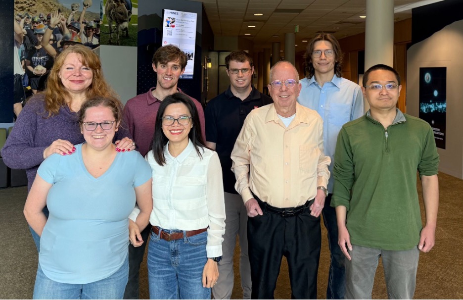 Eight Metropolitan State University of Denver students and faculty pose for a photo.