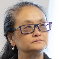 Donna Chen has long dark hair and rectangular glasses.