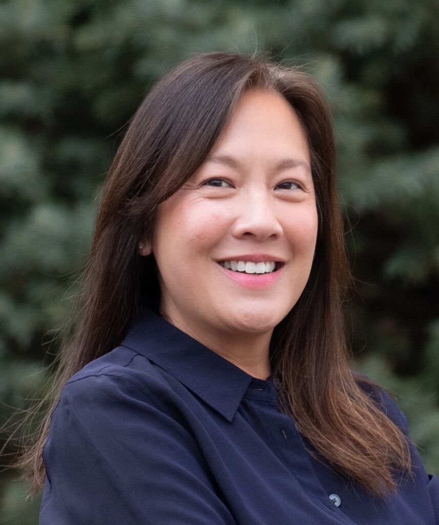 Natalie Rotelli has long brown hair and is wearing a navy blue dress shirt.