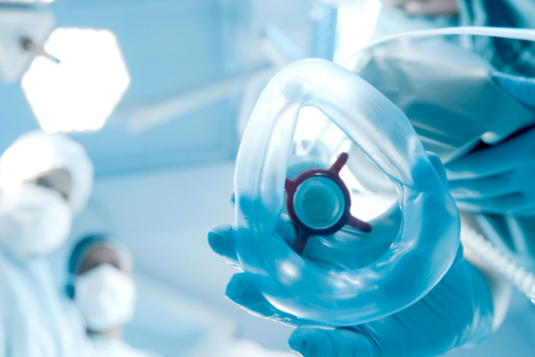 An anesthesiologist holding a breathing mask