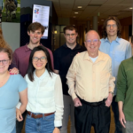 Eight Metropolitan State University of Denver students and faculty pose for a photo.