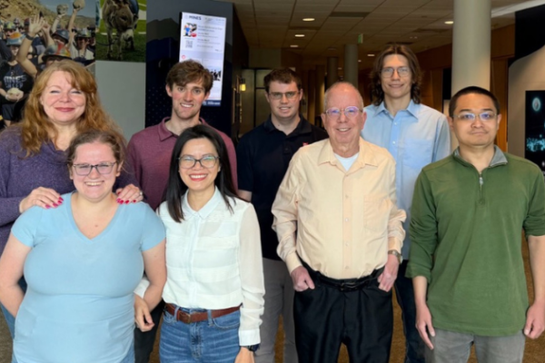 Eight Metropolitan State University of Denver students and faculty pose for a photo.