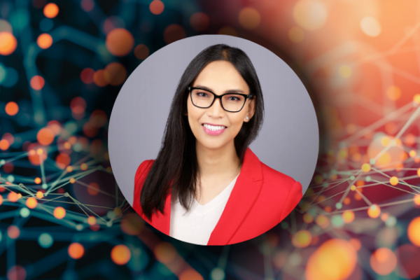 Margaret Gamalo's headshot. She has long, dark hair, glasses, and a red jacket.