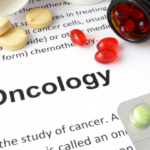 "Oncology" surrounded by various pills and medications.
