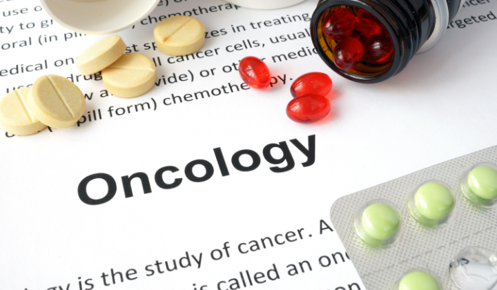 "Oncology" surrounded by various pills and medications.