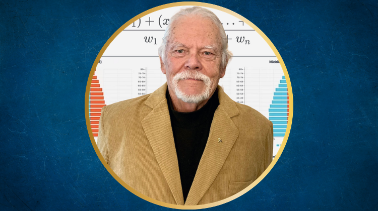 A white man in a tan sportcoat and a black shirt with a white beard