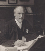 A black and white photo from the early 20th century of a man with short hair 